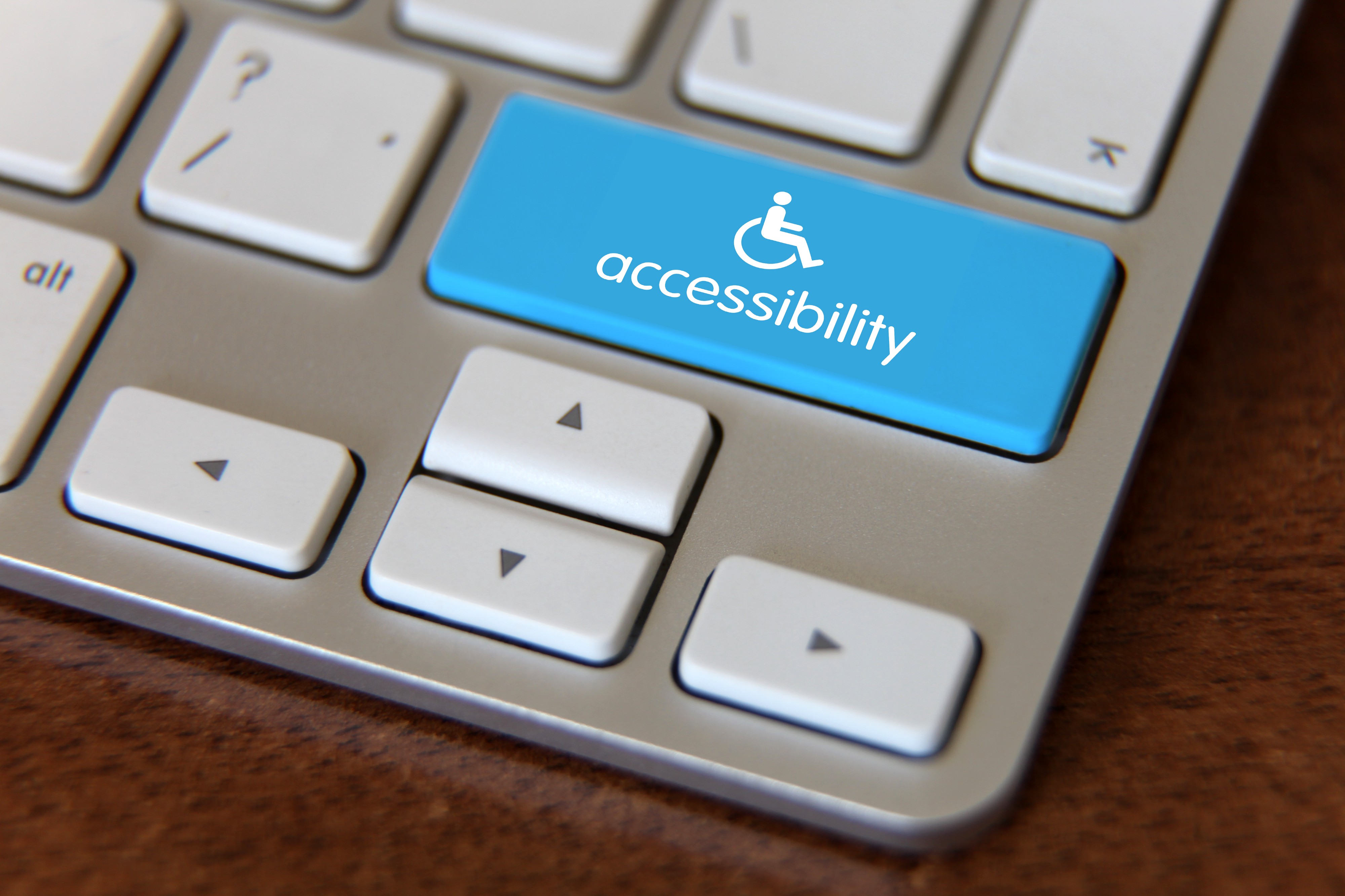 Computer keyboard with large blue key labeled "accessibility".