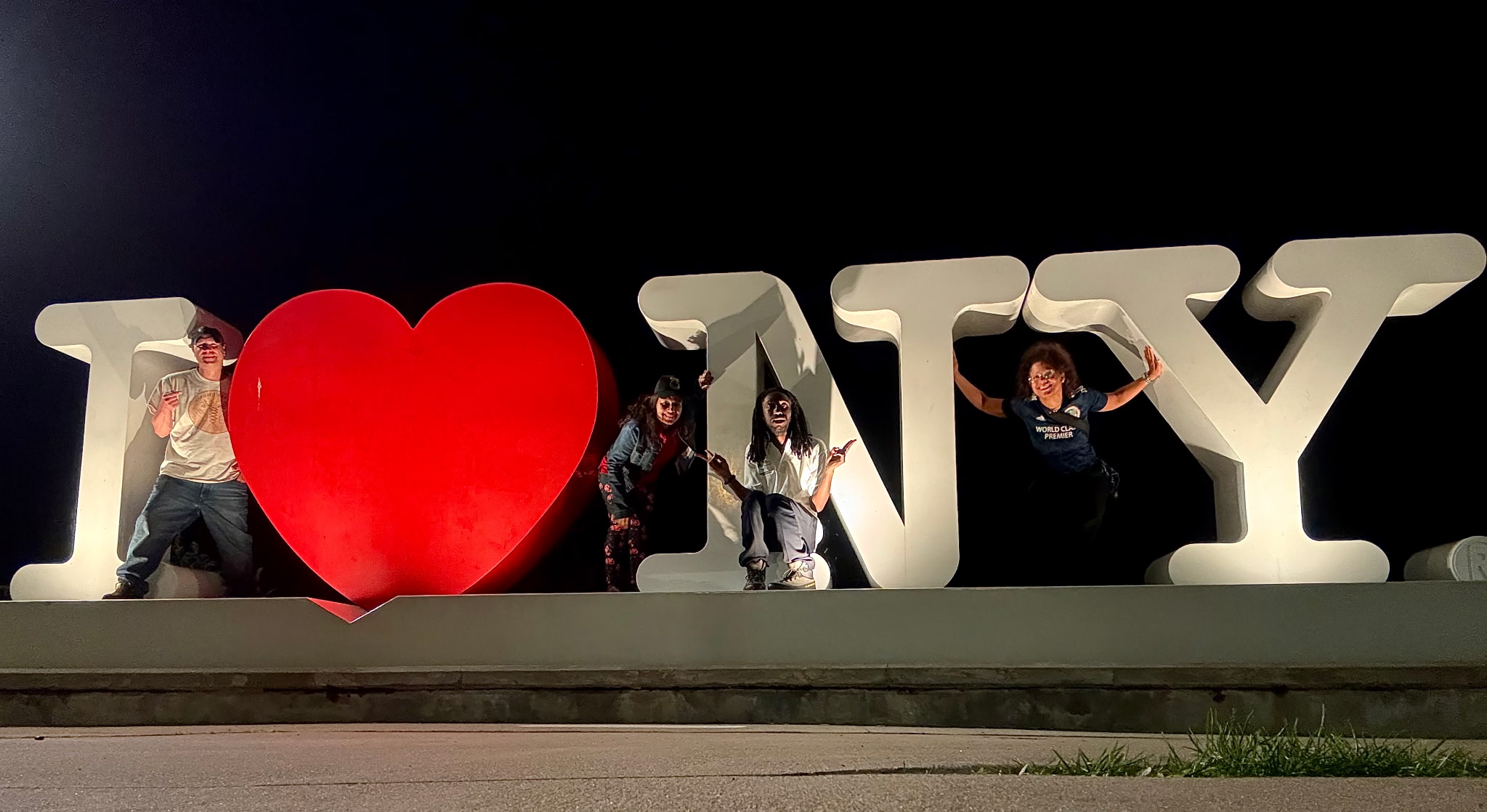 frieds at an I love NY sign in Geneva NY, in Seneca Lake