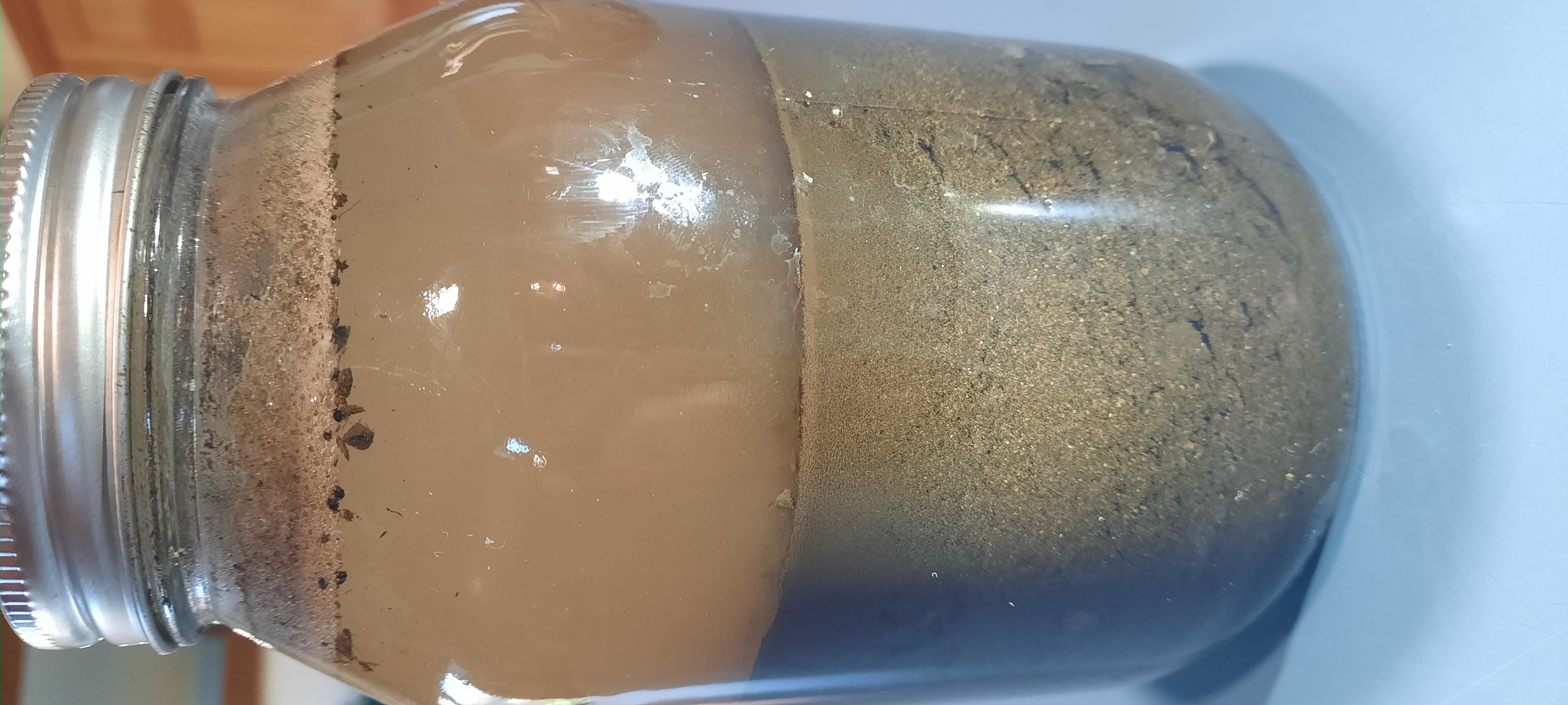 jar with soil in layers